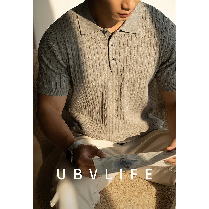 Men's khaki short sleeve business top on a hanger.