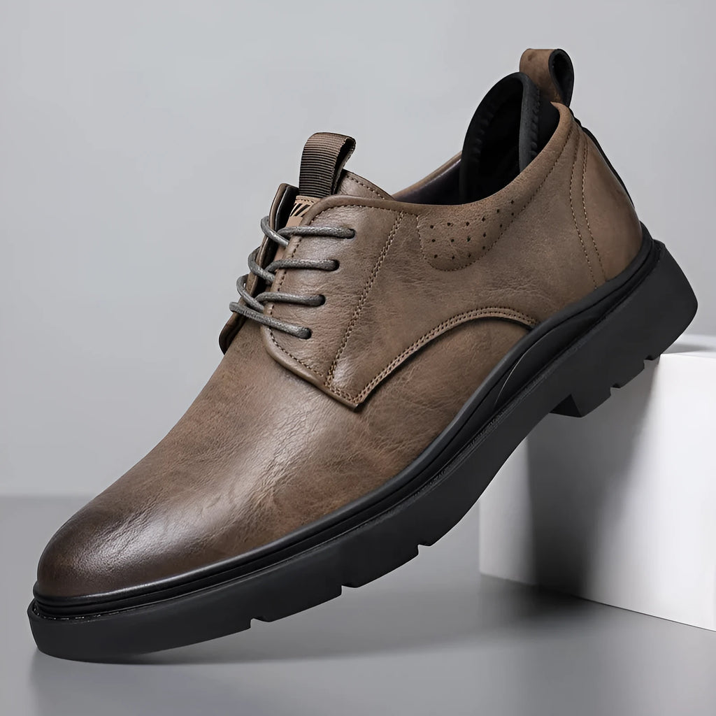 Men's black and brown leather sneaker with sewing line detail on a two-layer cowhide upper and rubber sole.