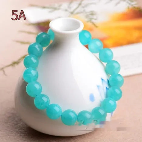 Grade 7A Amazonite natural scattered beads in ice blue and green, showing polished round and three-ring bead styles for bracelet making.