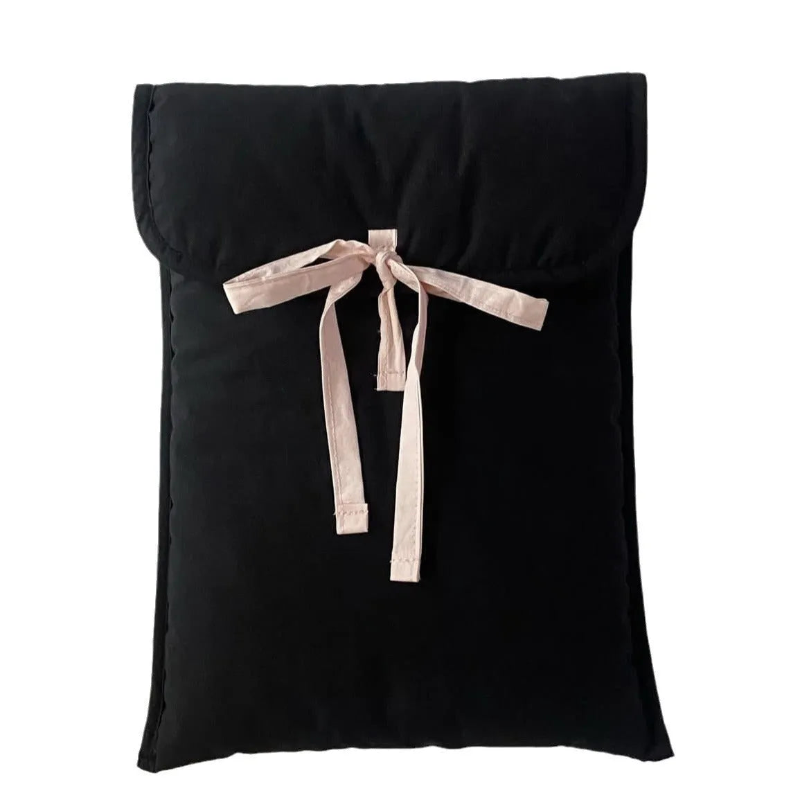 Women's black quilted laptop bag with ballet bow detailing and striped pattern showing laptop compartment
