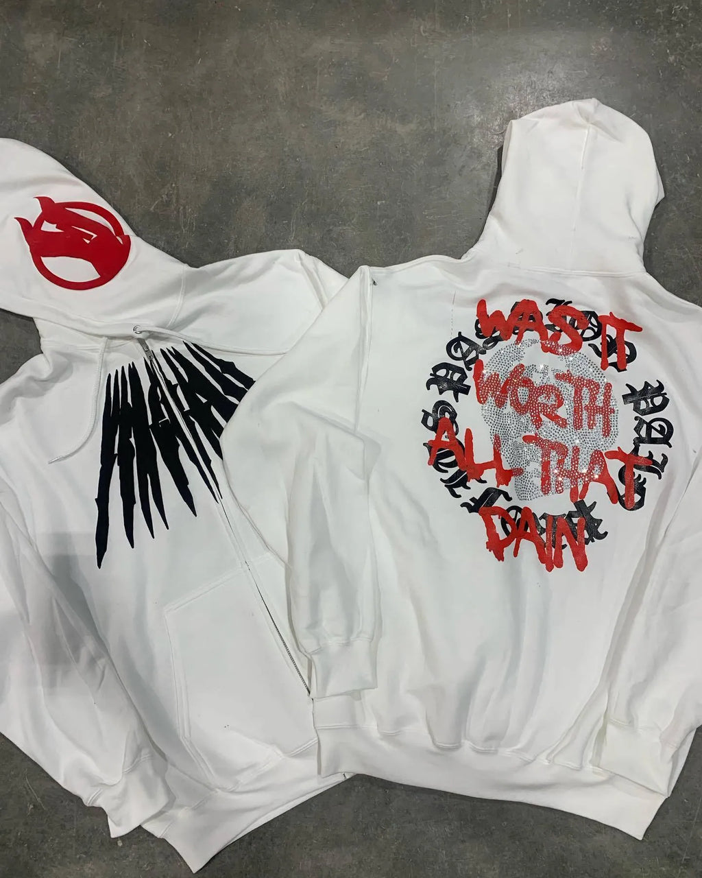 Black loose hooded sweatshirt with white printed skull pattern and rhinestone details on front