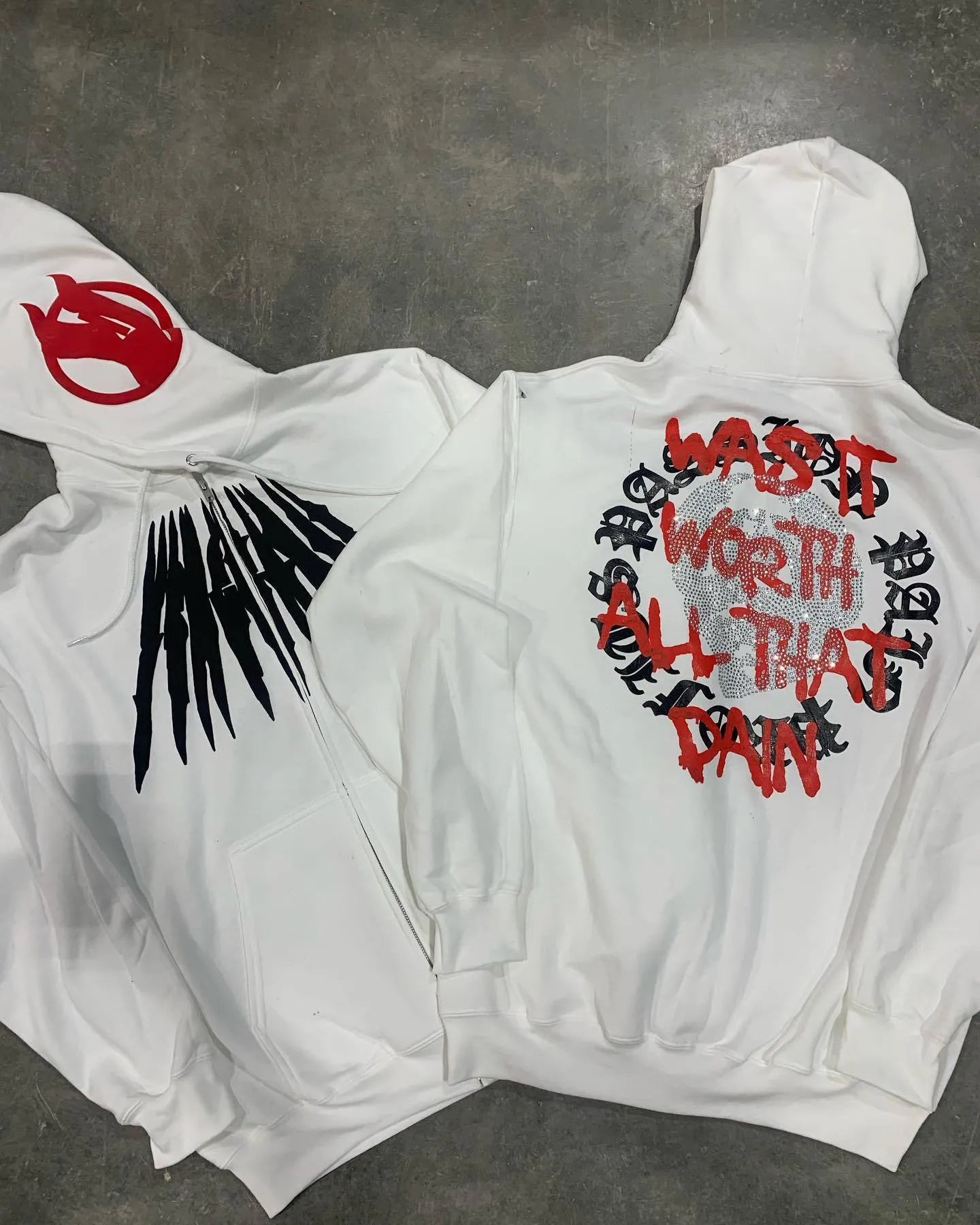 Black loose hooded sweatshirt with white printed skull pattern and rhinestone details on front