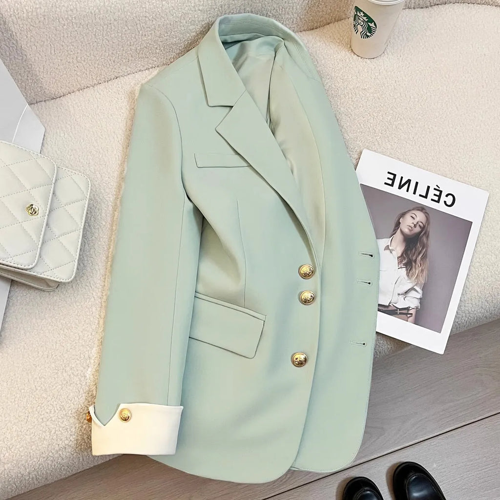 Milky white loose-fit women's trench coat with long sleeves and pockets on a hanger.