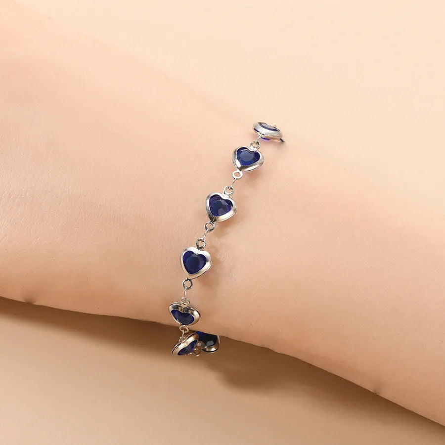 Devil's Eye geometric heart-shaped stainless steel bracelet in an electroplated colour on a wrist.