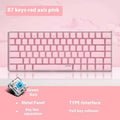 Compact white-backlit mechanical keyboard with 82 keys and metal case on a desk.