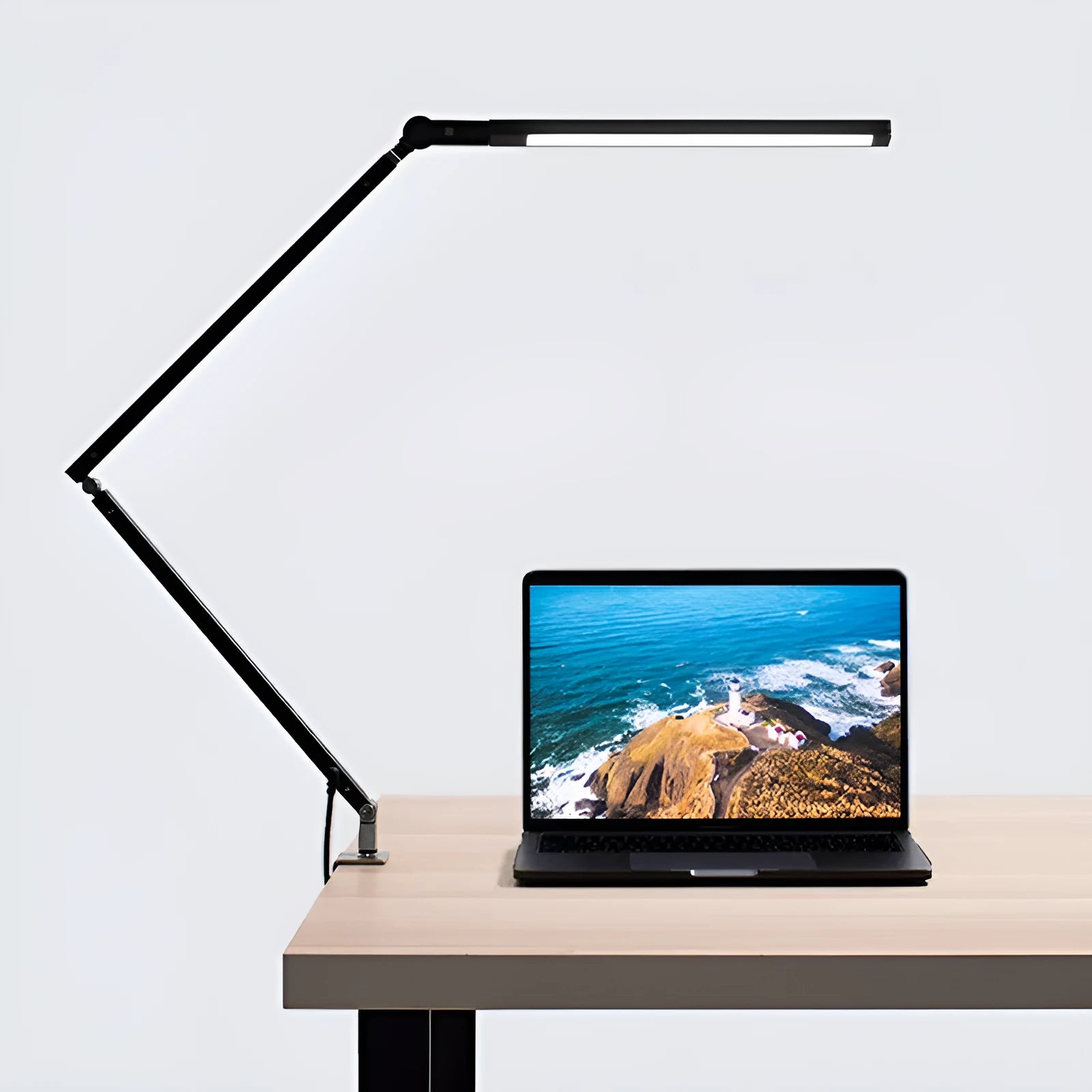 Aluminium clip-on desk lamp with a folding arm and remote control, shown in dazzling black finish.
