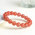 Natural cherry red agate scattered bead bracelet with polished stones on an adjustable strap.