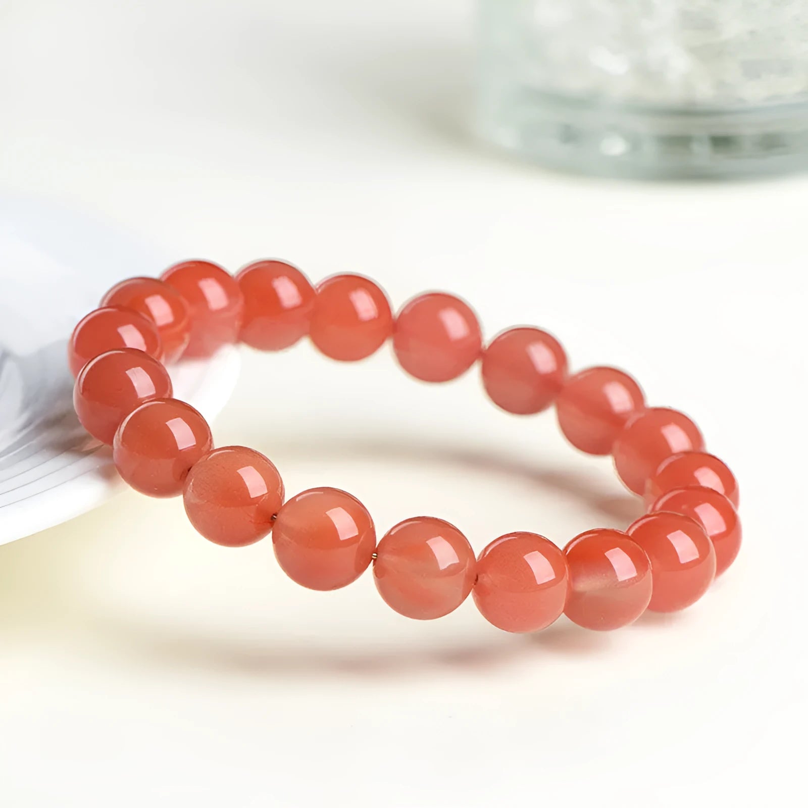 Natural cherry red agate scattered bead bracelet with polished stones on an adjustable strap.