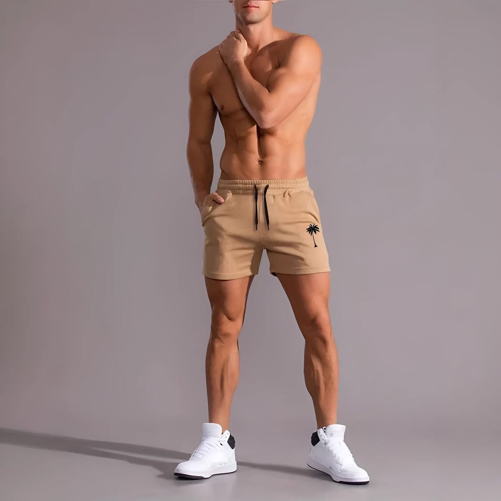 Men's khaki sports shorts with coconut palm leaf print, elastic waistband, straight cut design