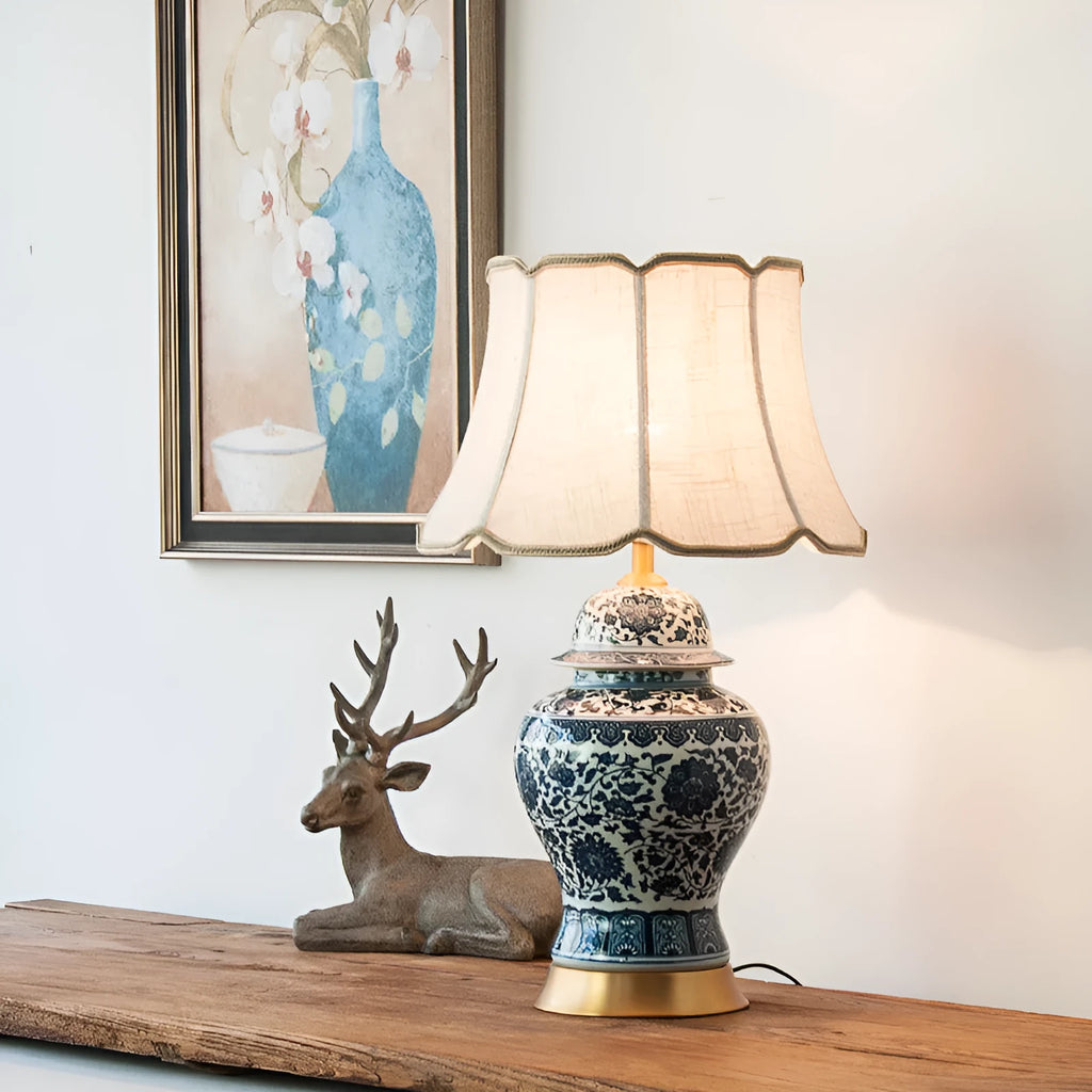 Chinese style blue and white porcelain table lamp with handmade ceramic base and cloth shade on bedside table