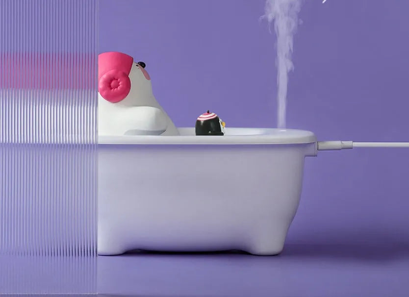 White USB-powered portable air humidifier and essential oil diffuser on a desk