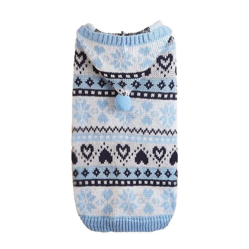 Blue knitted dog sweater with snowflake, love heart, and striped camouflage pattern on a small dog.