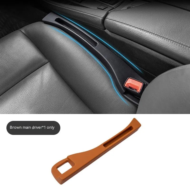 Black plastic car seat gap storage box with handle positioned between vehicle seats
