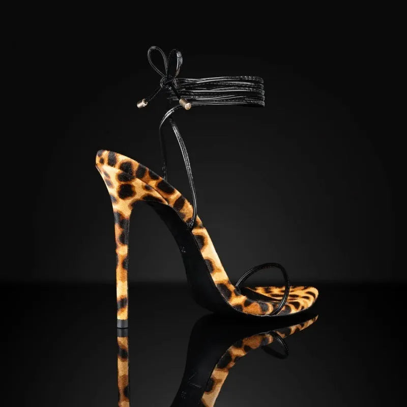 Women's leopard print Roman gladiator sandals with lace-up straps and a pointed toe.