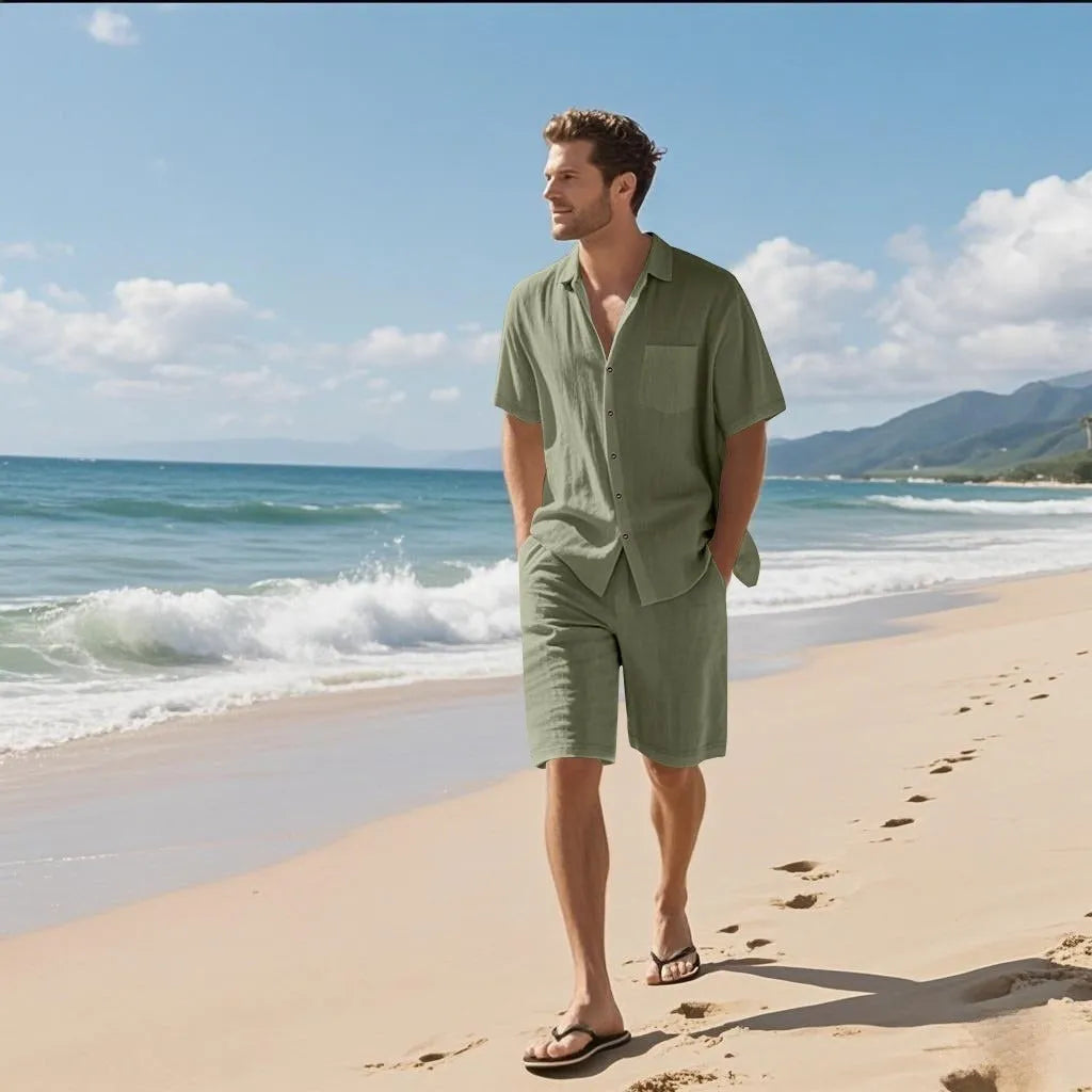 Man wearing a light blue linen blend short sleeve shirt and matching shorts beach set.