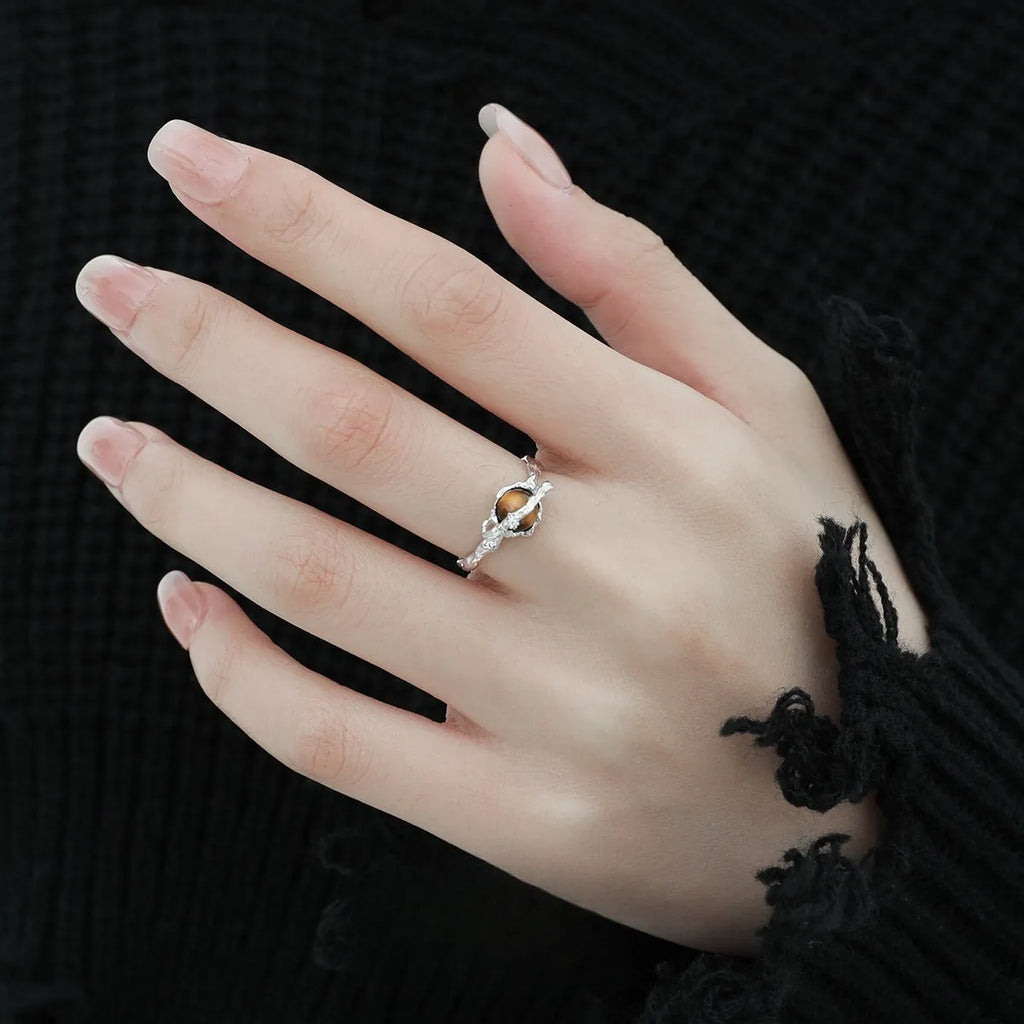 Saturn-themed adjustable open ring in electroplated white gold colour with tigereye gemstone detail