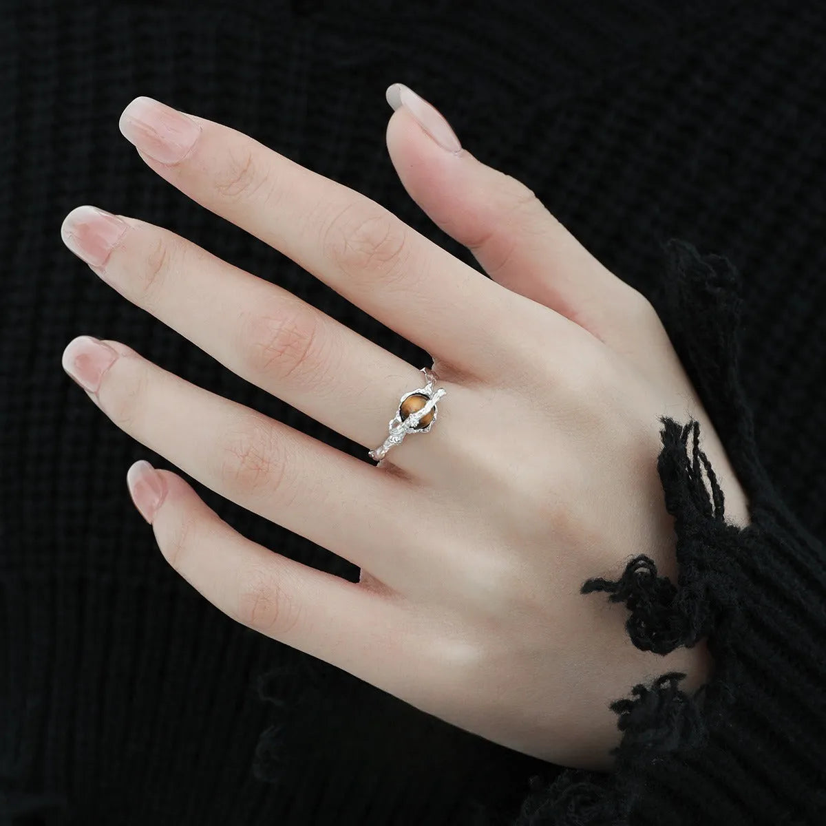 Saturn-themed adjustable open ring in electroplated white gold colour with tigereye gemstone detail
