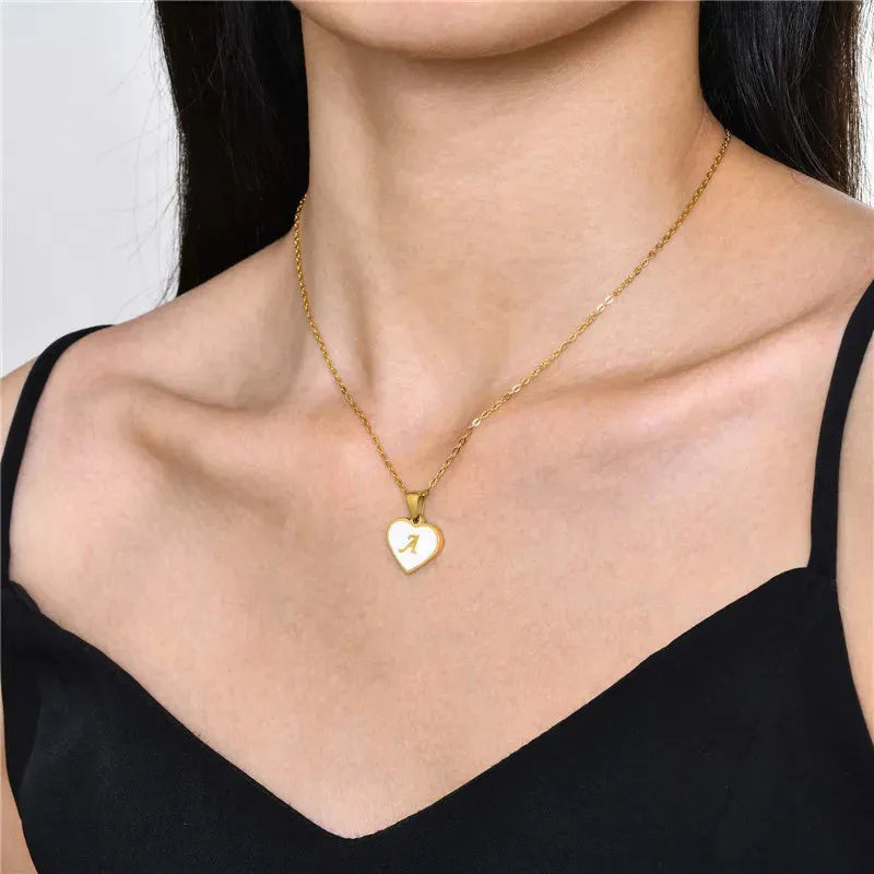 Gold plated heart pendant necklace with white shell centre and personalised letter engraving on adjustable chain