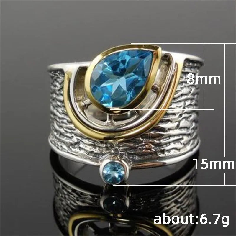 Blue zircon drop shape ring with Chinese-inspired design in alloy setting