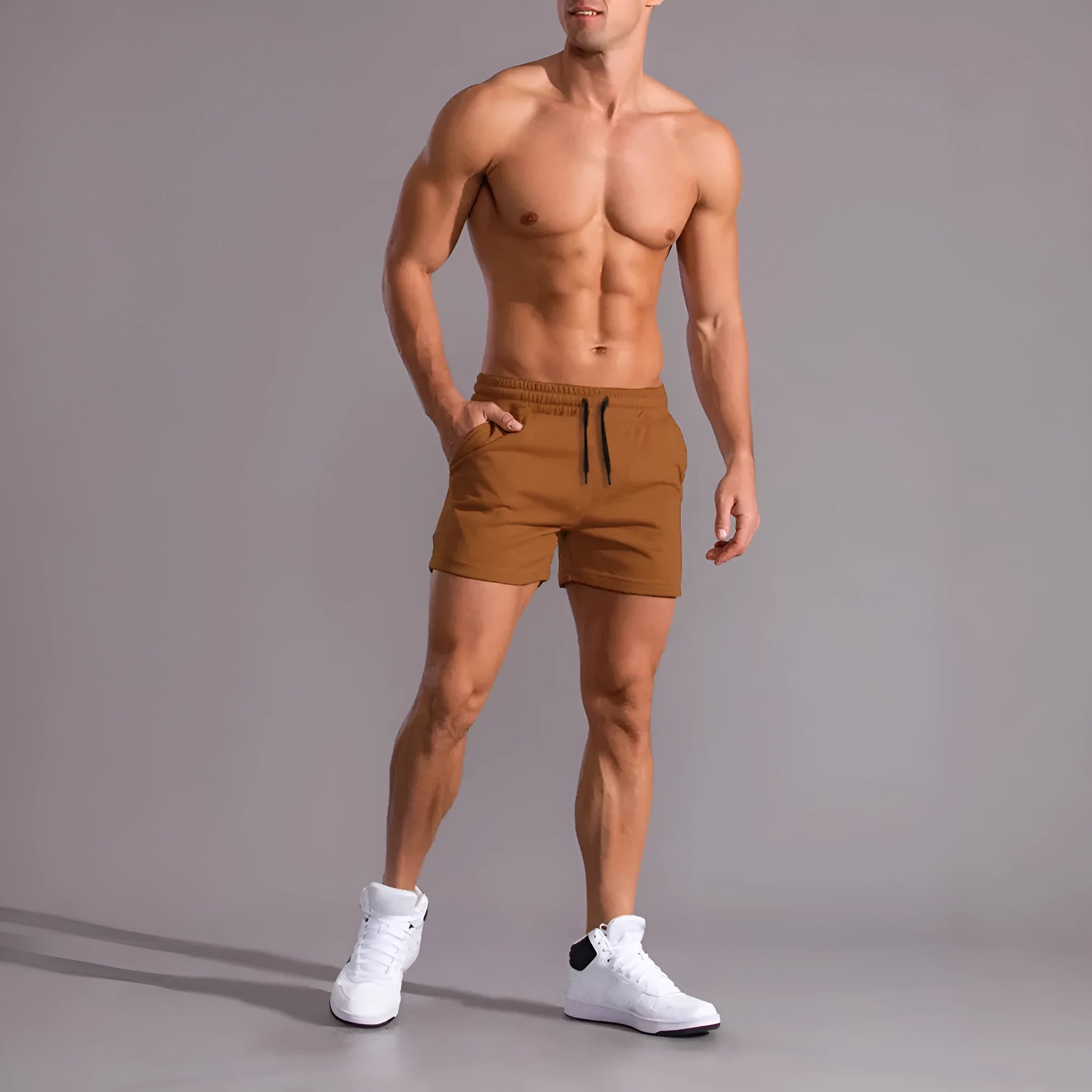 Men's black, khaki, and light brown drawstring casual shorts laid flat, showing loose fit and elasticated waistband.