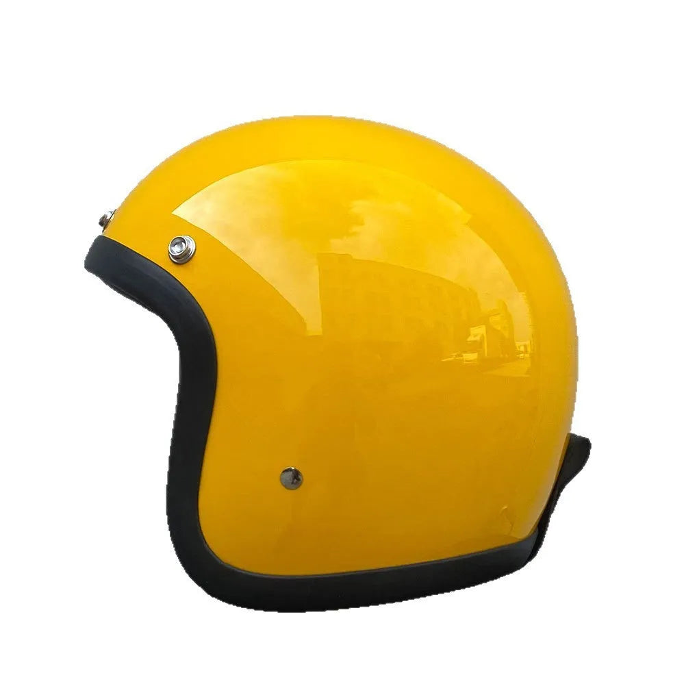 A retro-style motorcycle half helmet made from grey fibreglass, shown from the side.
