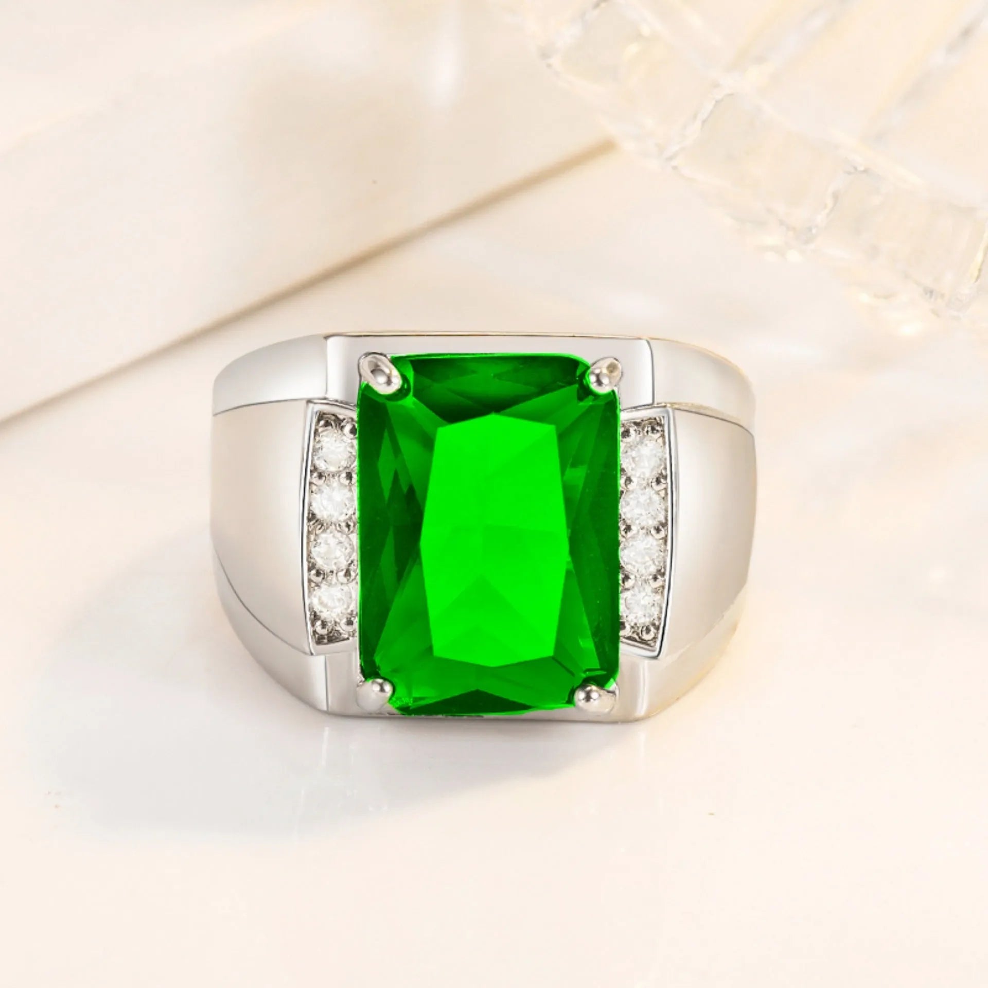 Adjustable open geometric ring with a coloured rhinestone stone on a copper band with plated finish.