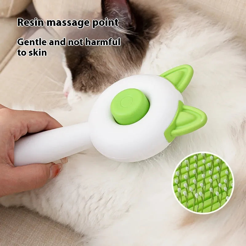 Circular greenish white pet grooming brush with stainless steel teeth and rubber massage nodules.