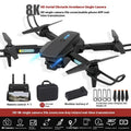 S138 black folding drone with carbon fibre appearance, showcasing folded arms and dual cameras for obstacle avoidance aerial photography.