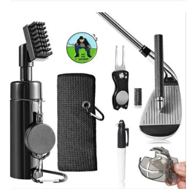 Black plastic golf club groove cleaning tool on a grassy surface with a golf ball nearby