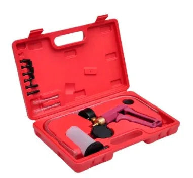 Aluminium alloy manual vacuum air blow gun tool for car repair on a workbench.