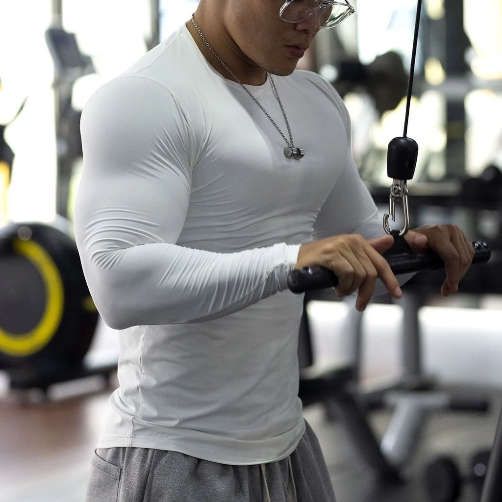 Men's black slim-fit long sleeve fitness tights made from quick-dry fabric for exercise.