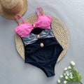 Women's brown one-piece swimsuit with high elasticity and matching beige skirt laid flat.