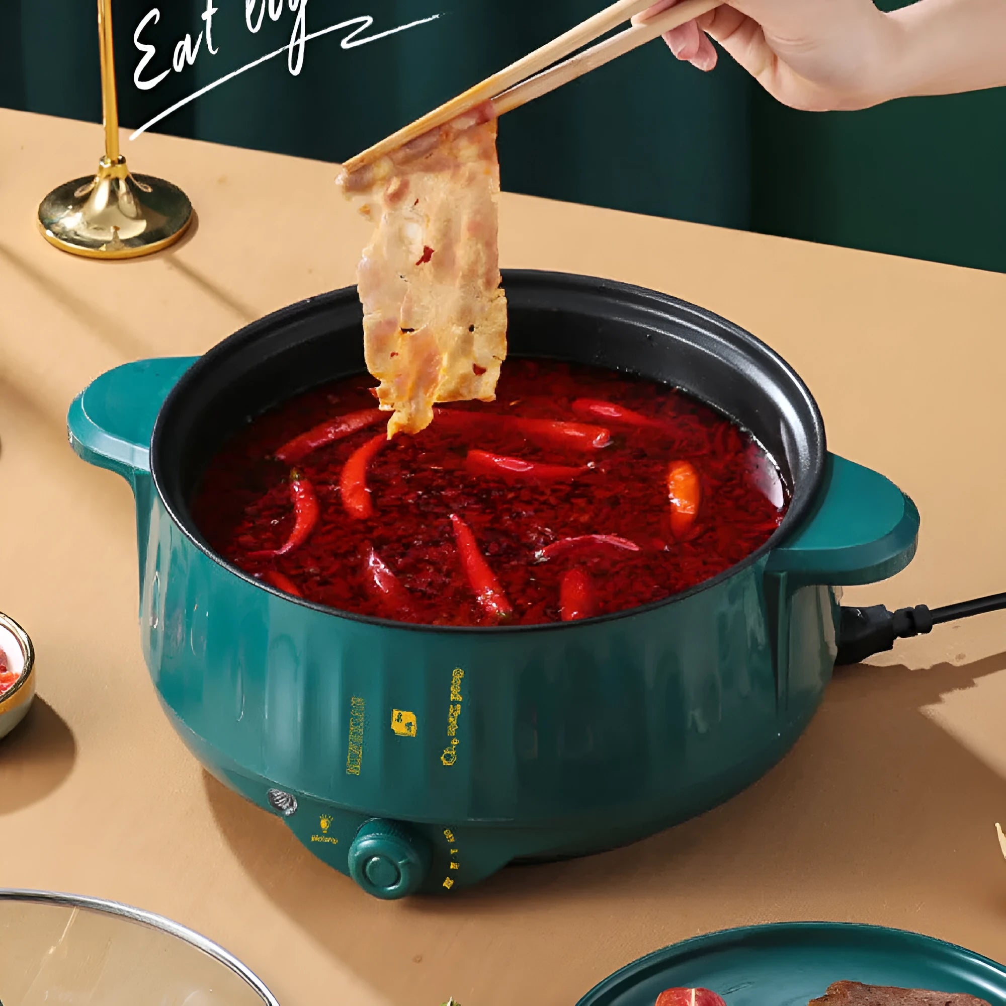 White electric multi-function hot pot with non-stick integrated cooking pot on a kitchen counter.